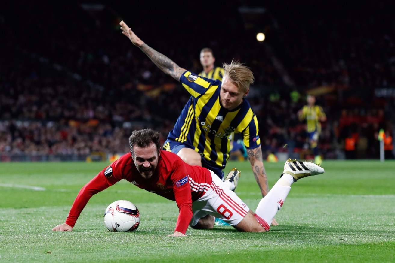 Fenerbahce's Simon Kjaer brings down Juan Mata inside the box, prompting a Manchester United penalty. Photo: Martin Rickett / PA Wire