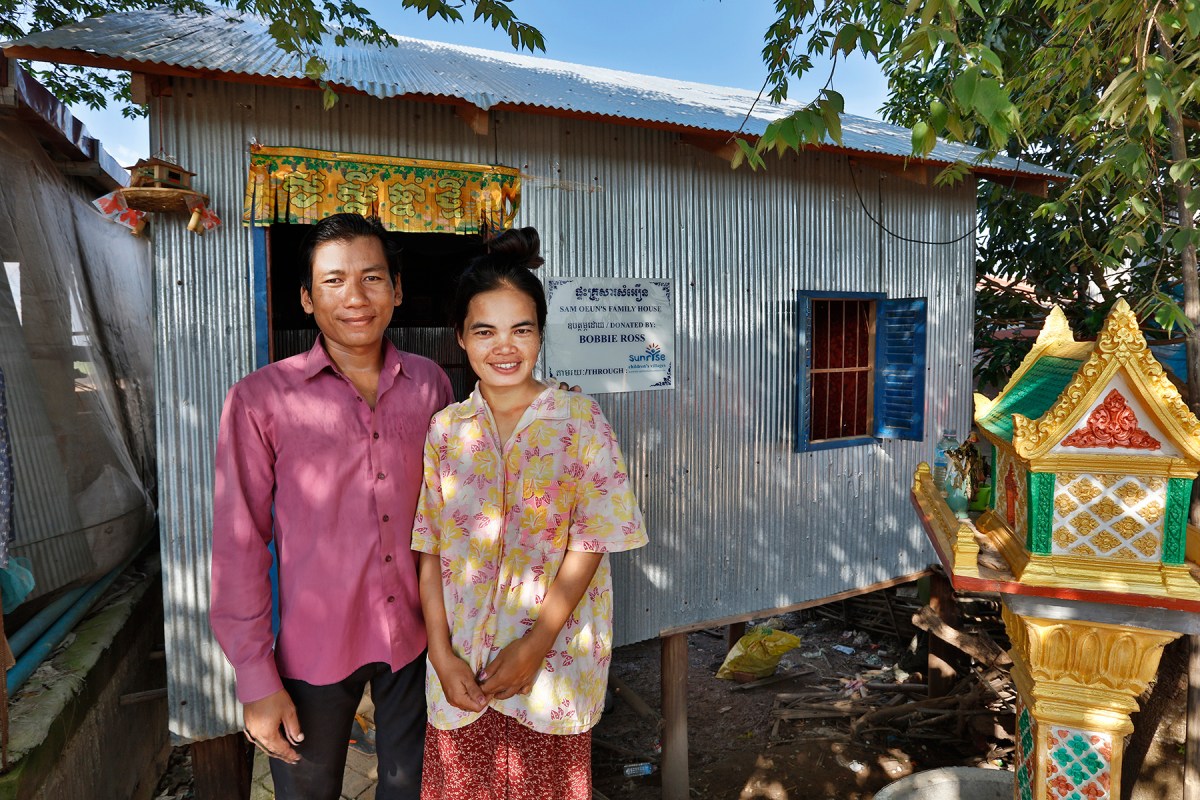 Sam Ouen and his wife outside their house in Kom Nor Thmor village - a new house like this costs $2000. Photo: Tony Lewis
