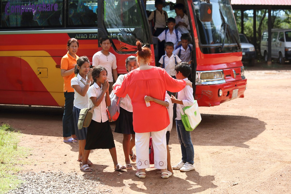Geraldine Cox greets orphan children at Sunrise Kandal Province as they arrive home after from attending school for the morning. Photo: Tony Lewis