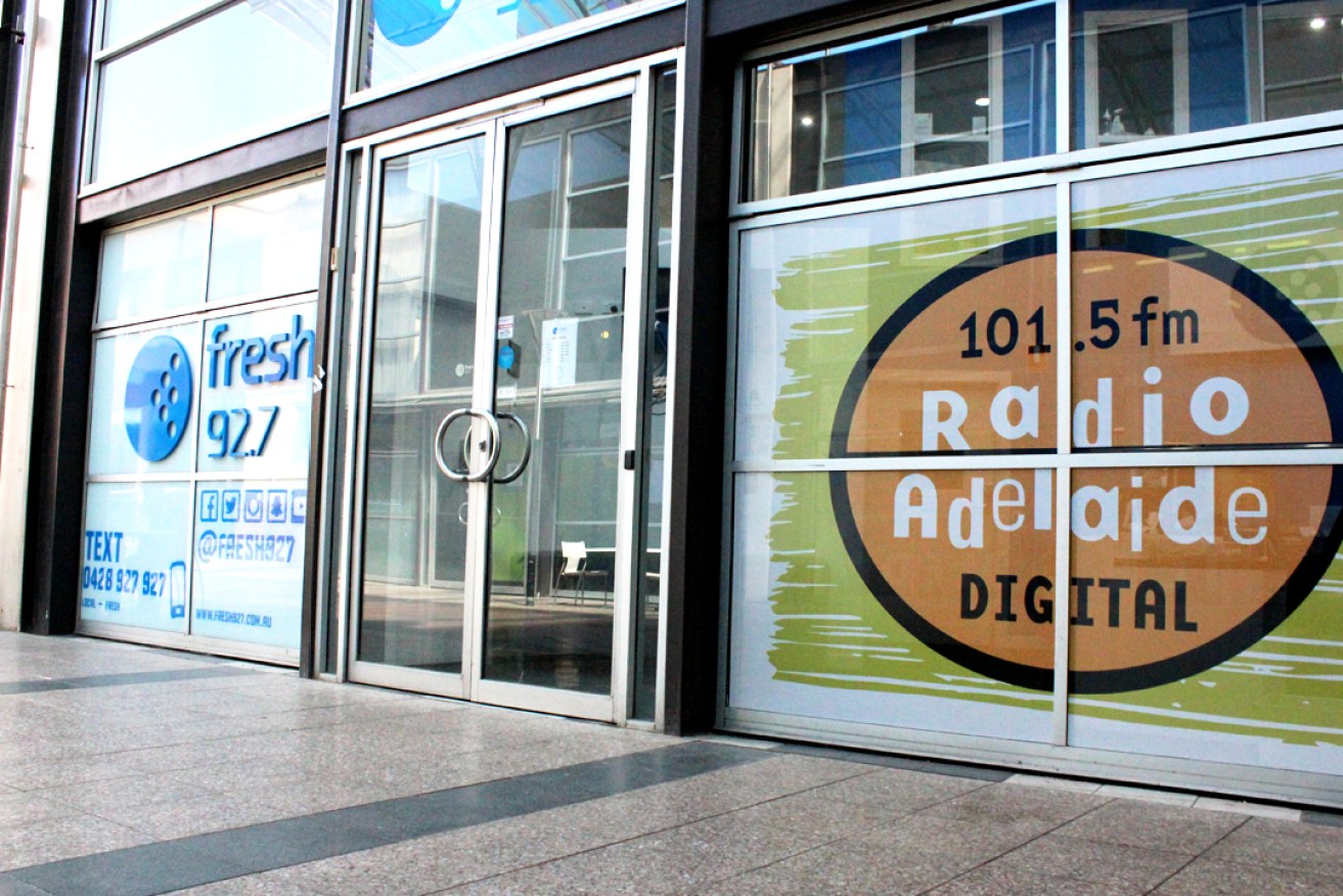 Radio Adelaide's branding seen in the window of its city studios. Photo: Jordan Patrick/InDaily.