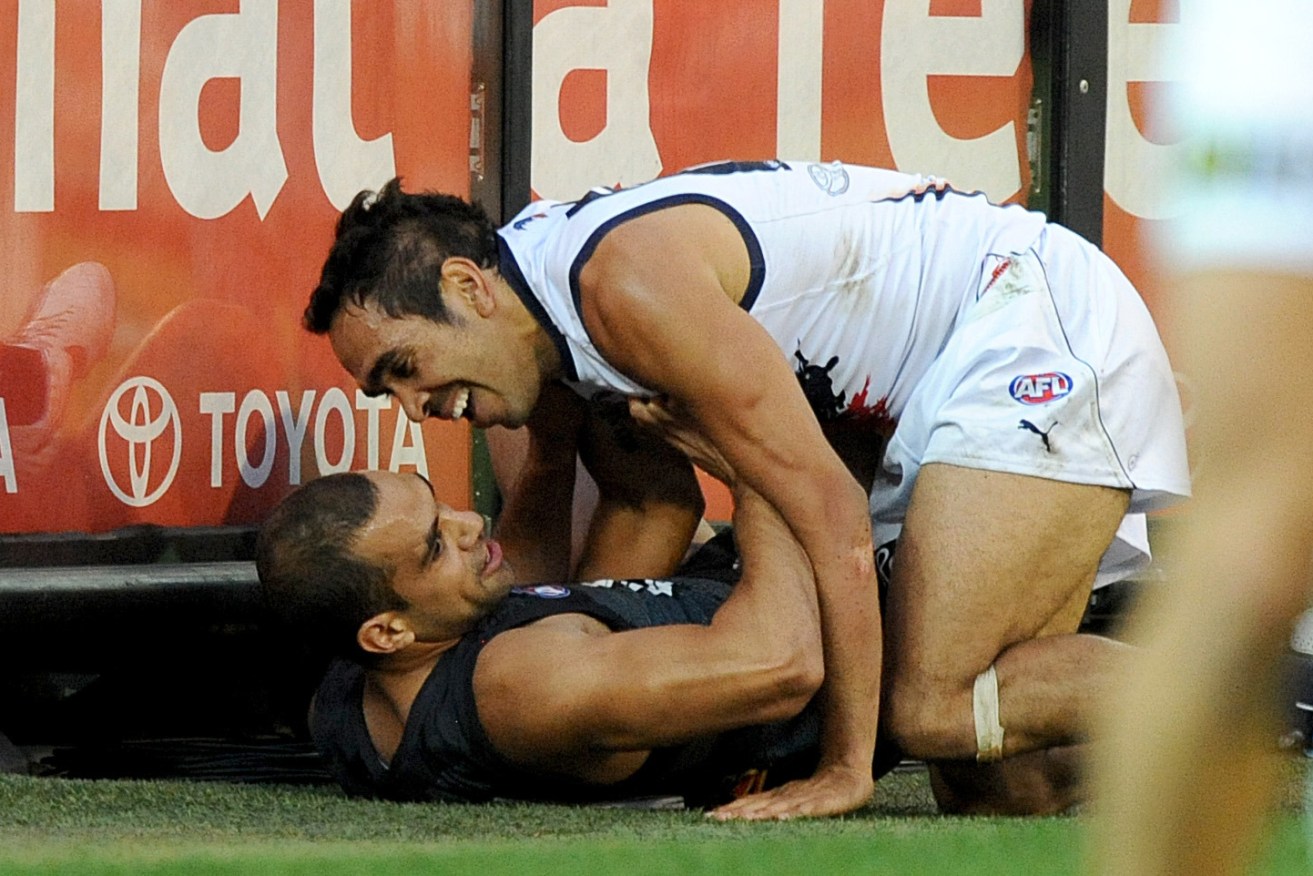 Eddie Betts tussles with ex-teammate and friend Chris Yarran during a Crows-Carlton clash in 2014. Photo: Joe Castro / AAP