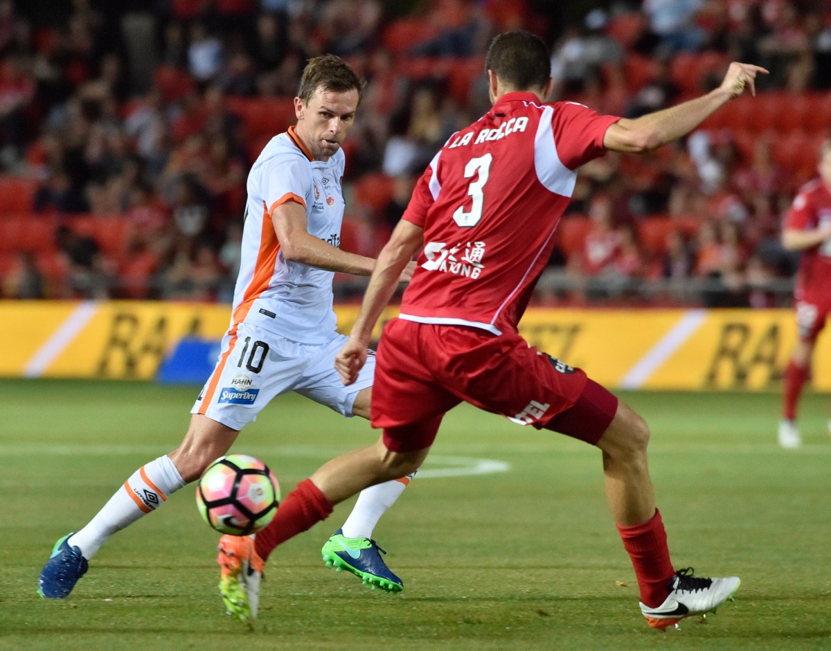 Brett Holeman of Brisbane Roar gets a ball past Lacopo La Rocca of United during the Round 6 A-League match between Adelaide United and Brisbane Roar FC at Hindmarsh Stadium in Adelaide, Friday, Nov. 11, 2016. (AAP Image/David Mariuz) NO ARCHIVING, EDITORIAL USE ONLY