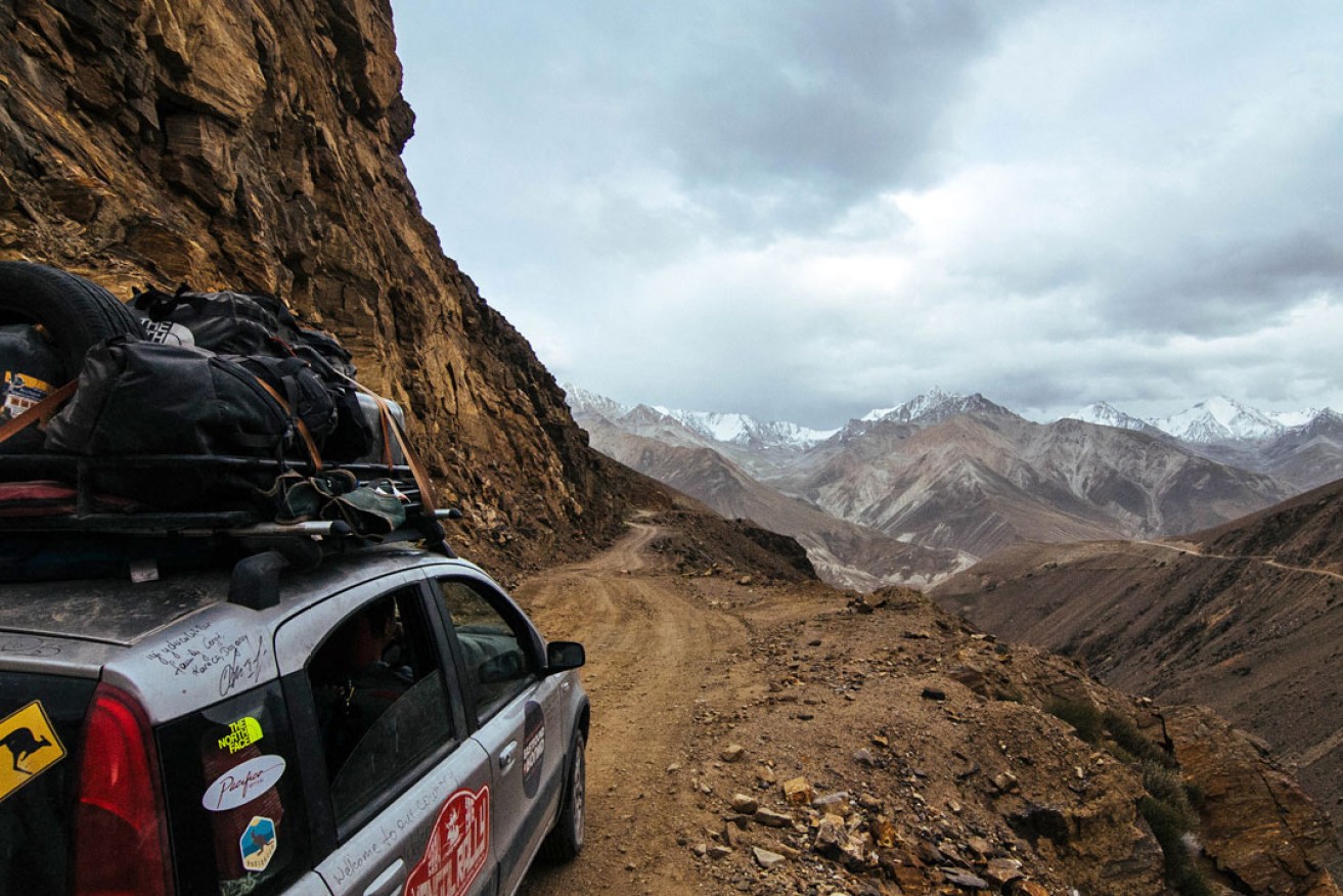 The team drives on an isolated track high in the Pamir Mountains, Tajikistan.  Photo: Ashton Papazahariakis