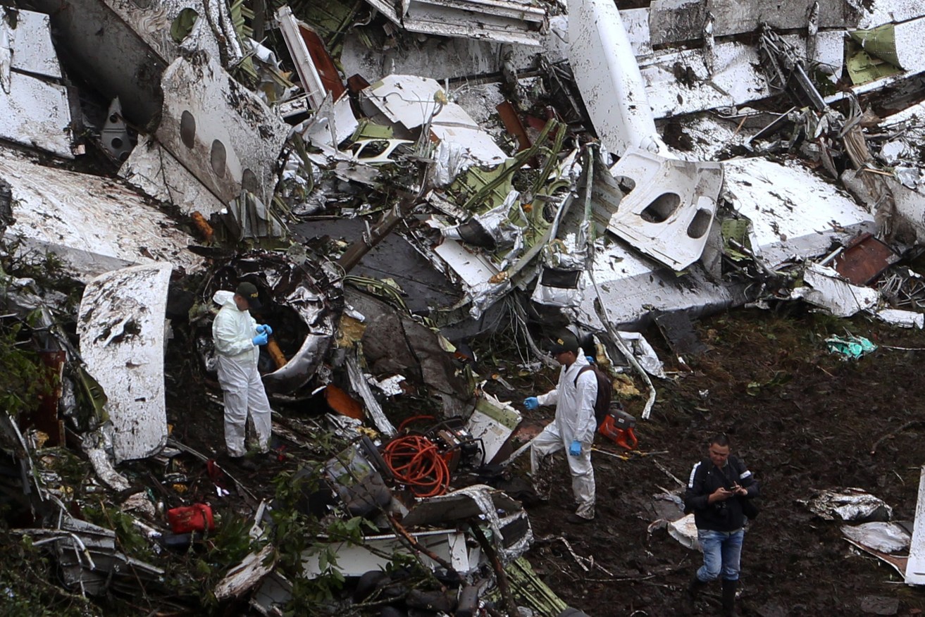 Rescue workers work at the scene of the plane crash. Photo: EPA/Luis Eduardo Noriega
