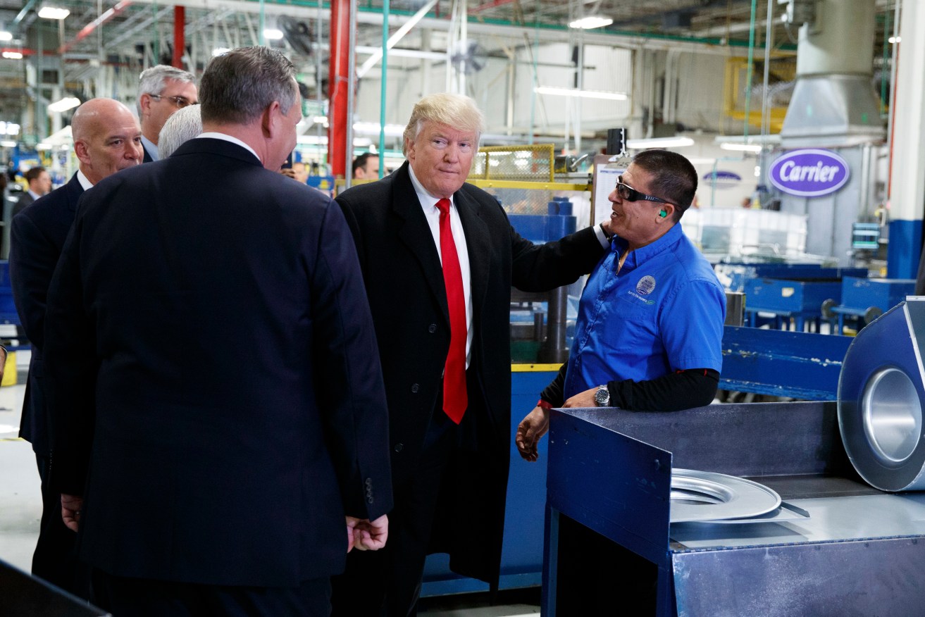 President-elect Donald Trump talks with workers during a visit to the Carrier factory in Indianapolis. Photo: AP/Evan Vucci