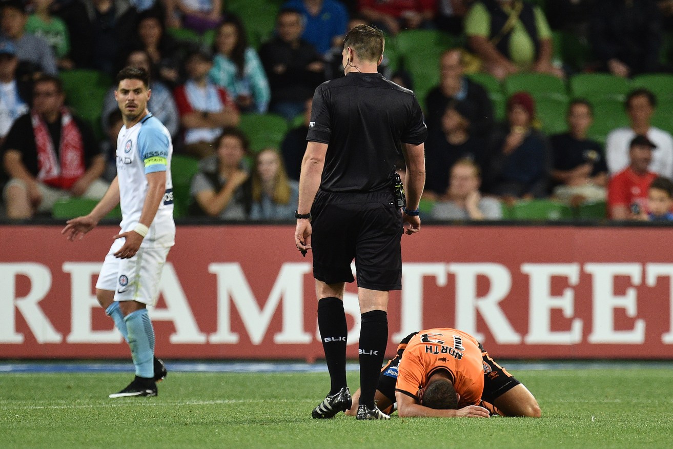 Melbourne City's Bruno Fornaroli looks back at Jade North, after the Brisbane Roar player took a dive in front of referee Shaun Evans. Photo: Julian Smith / AAP