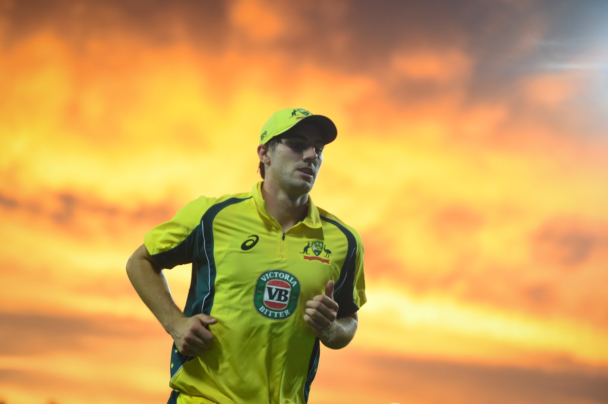 Pat Cummins of Australia looks on as the sun sets during the second One Day International between Australia and New Zealand at Manuka Oval in Canberra, Tuesday, Dec. 6, 2016. (AAP Image/Lukas Coch) NO ARCHIVING, EDITORIAL USE ONLY, IMAGES TO BE USED FOR NEWS REPORTING PURPOSES ONLY, NO COMMERCIAL USE WHATSOEVER, NO USE IN BOOKS WITHOUT PRIOR WRITTEN CONSENT FROM AAP