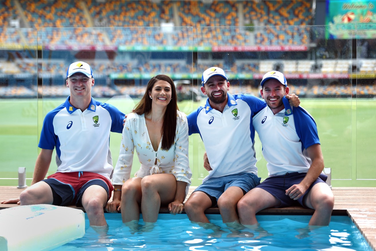 Chadd Sayers (right) with bowling rivals Jackson Bird (left) and Nathan Lyon, as well as former Olympic swimmer Stephanie Rice at a pool installed at Gabba. Photo: AAP/Dan Peled