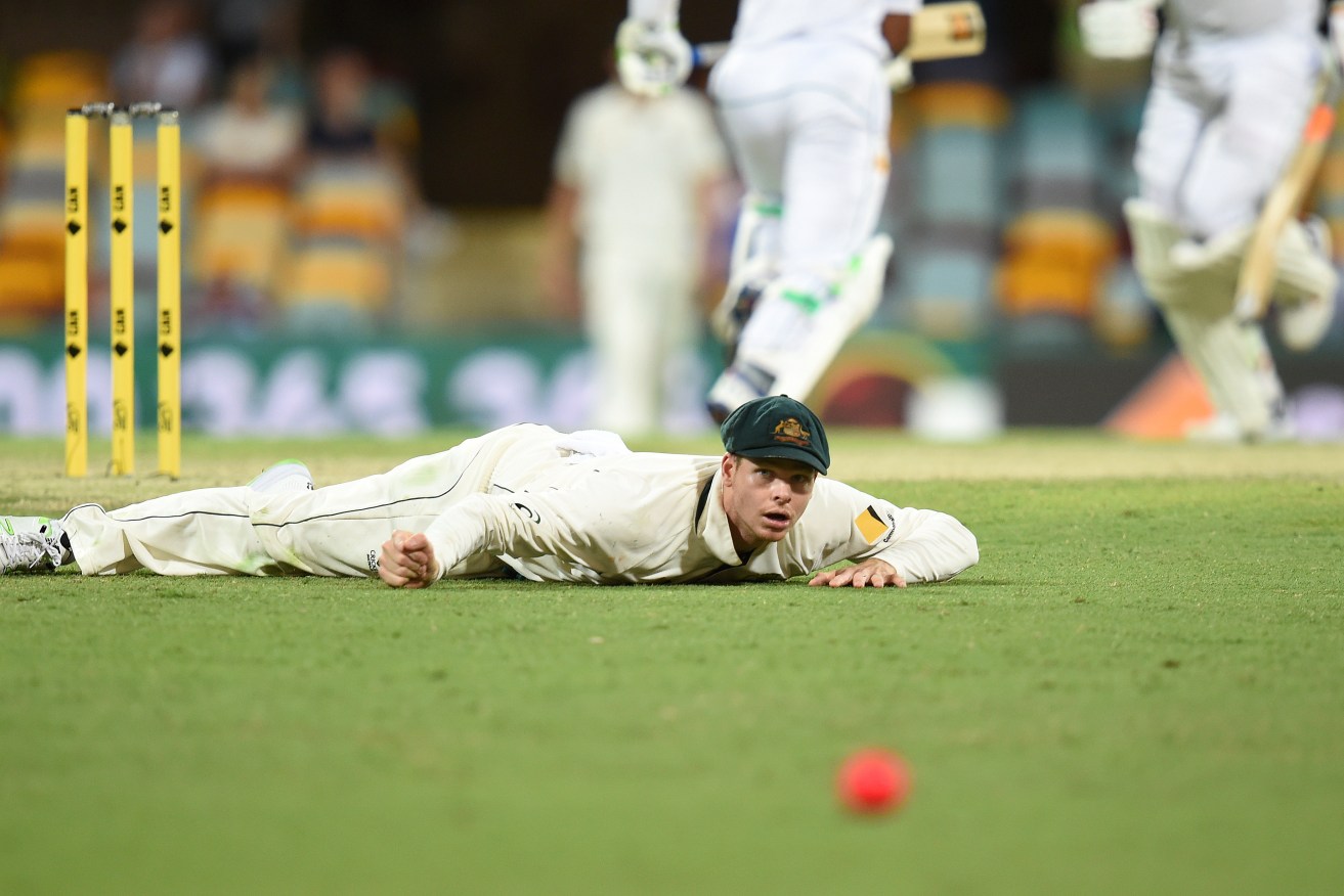 Steve Smith watches the ball races away to the boundary for four. Photo: Dave Hunt / AAP