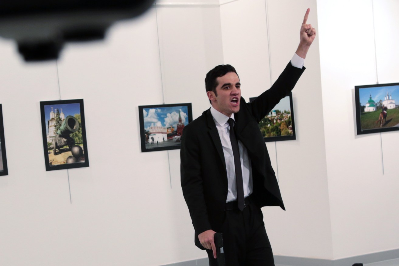 The gunman shouts after shooting Andrei Karlov, the Russian Ambassador to Turkey, at a photo gallery in Ankara. Photo: AP/Burhan Ozbilici
