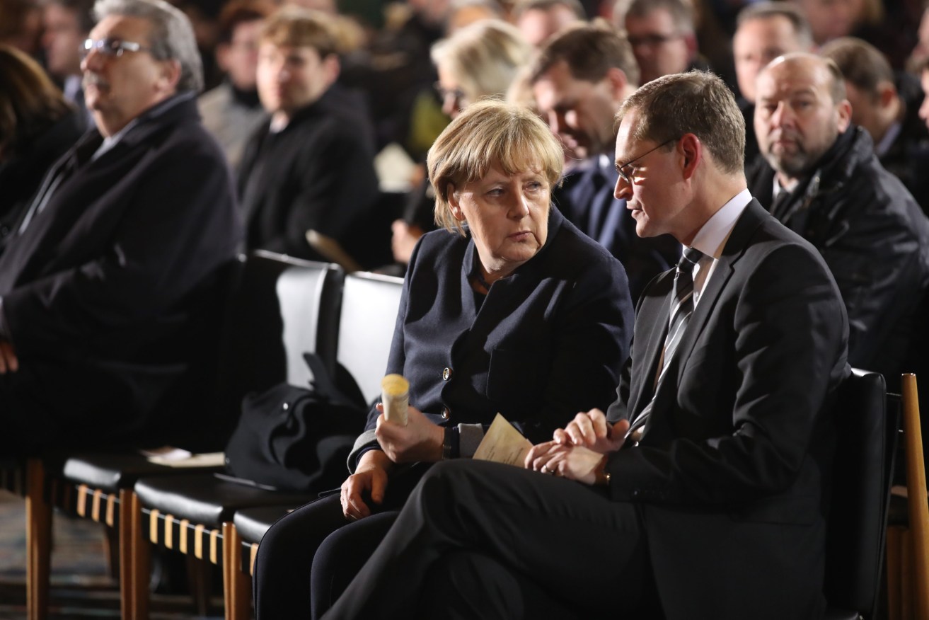 German Chancellor Angela Merkel and Berlin Mayor Michael Mueller  attend a memorial service in the Kaiser Wilhelm Memorial Church. Photo: EPA/Michael Kappeler