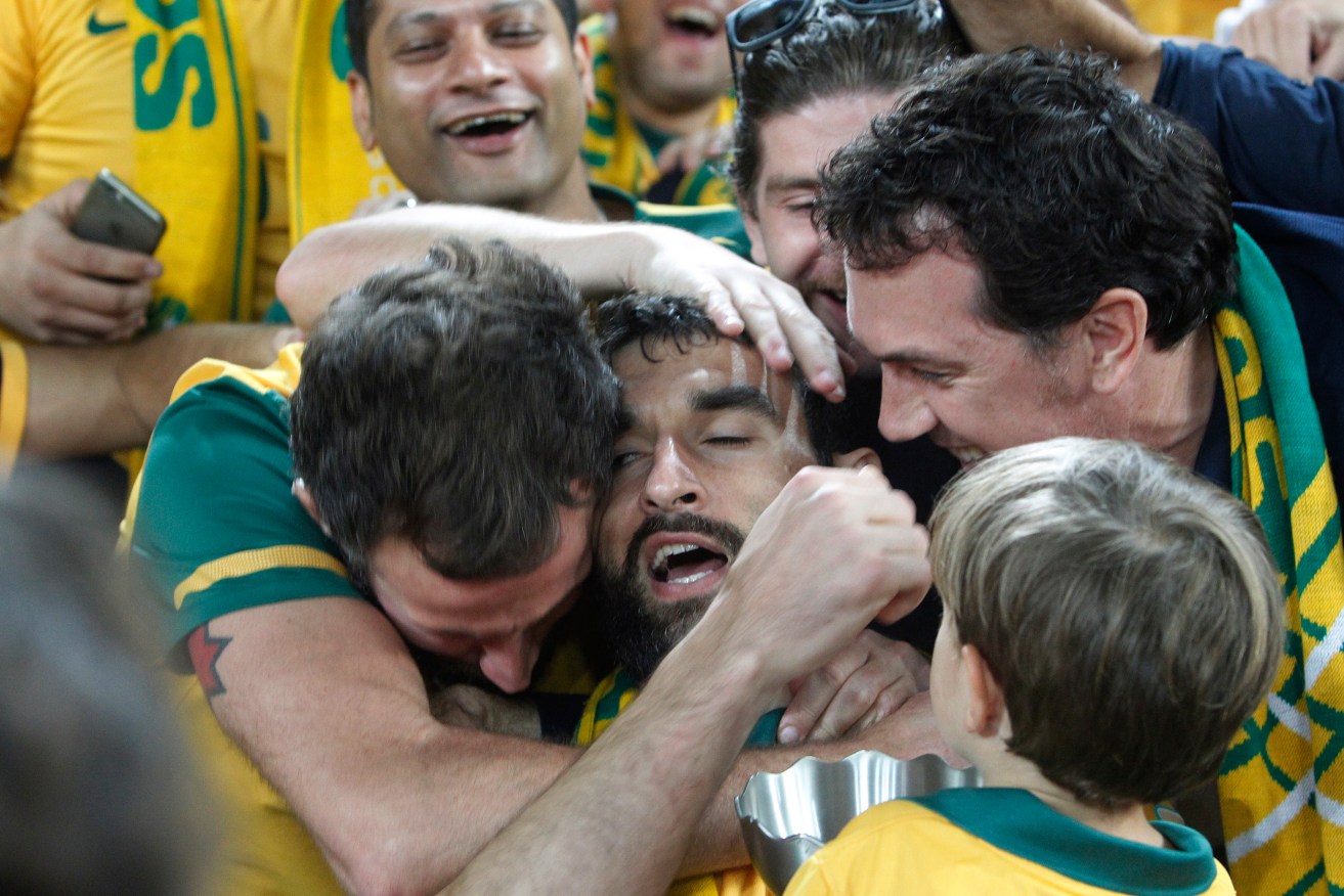 Mile Jedinak celebrates with fans after his Socceroos won the 2015 AFC Asian Cup - a success for Australia both on and off the field. Photo: Quentin Jones / AP