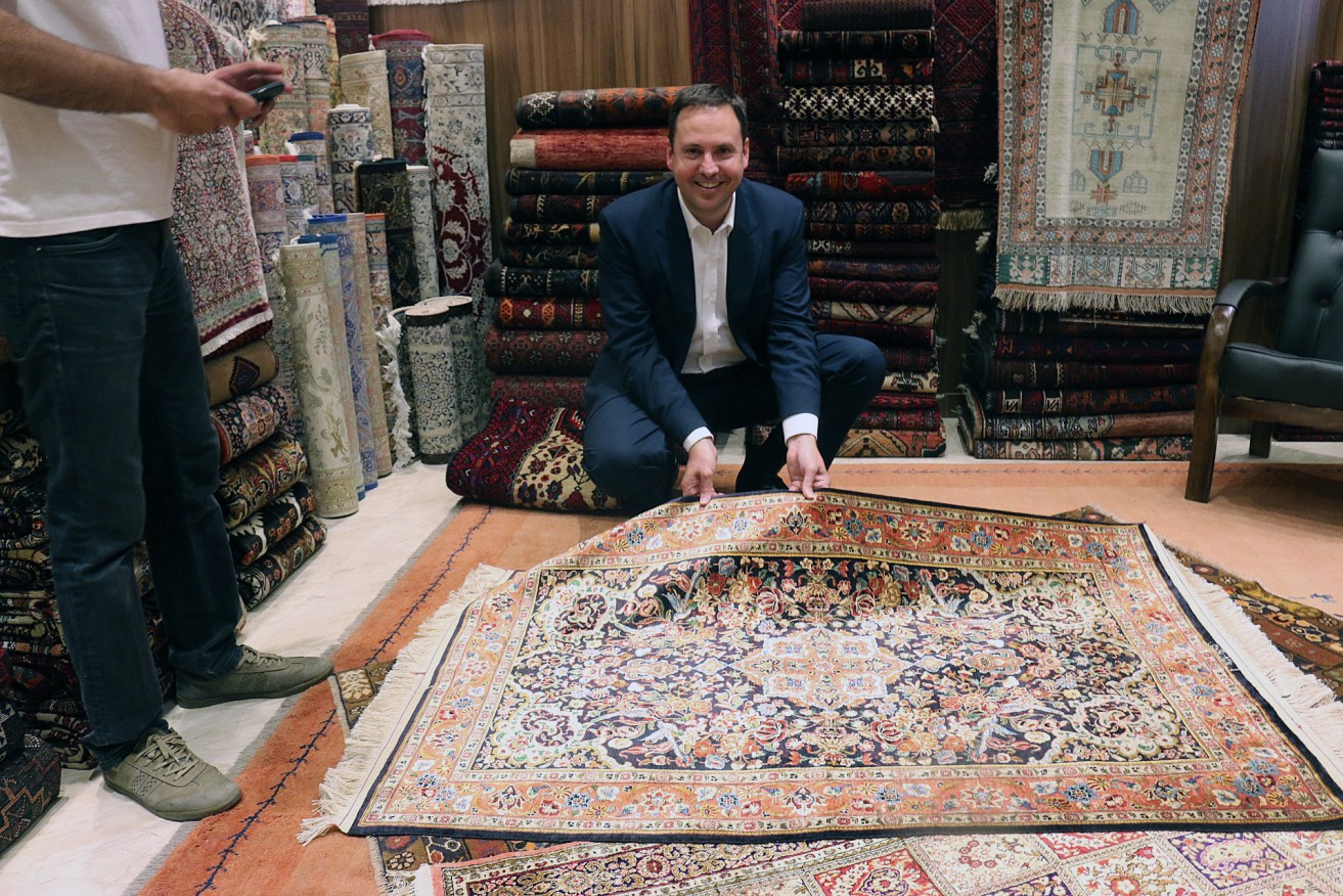 Trade Minister Steve Ciobo with a Persian carpet seller in the Grand Bazaar in Tehran, Iran, during a business delegation trip last year. Photo: AAP/Rashida Yosufzai