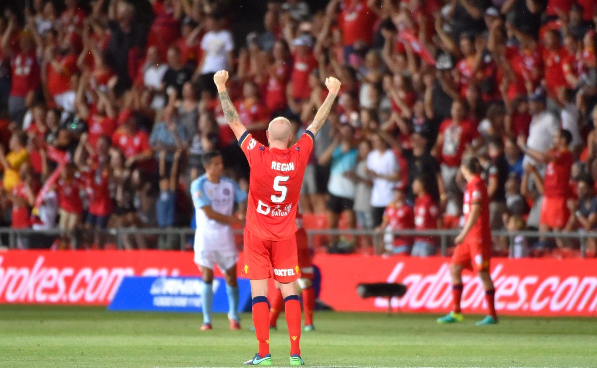 Taylor Regan raises his fists to the crowd after the Reds' breakthrough win against Melbourne City. Photo: David Mariuz / AAP