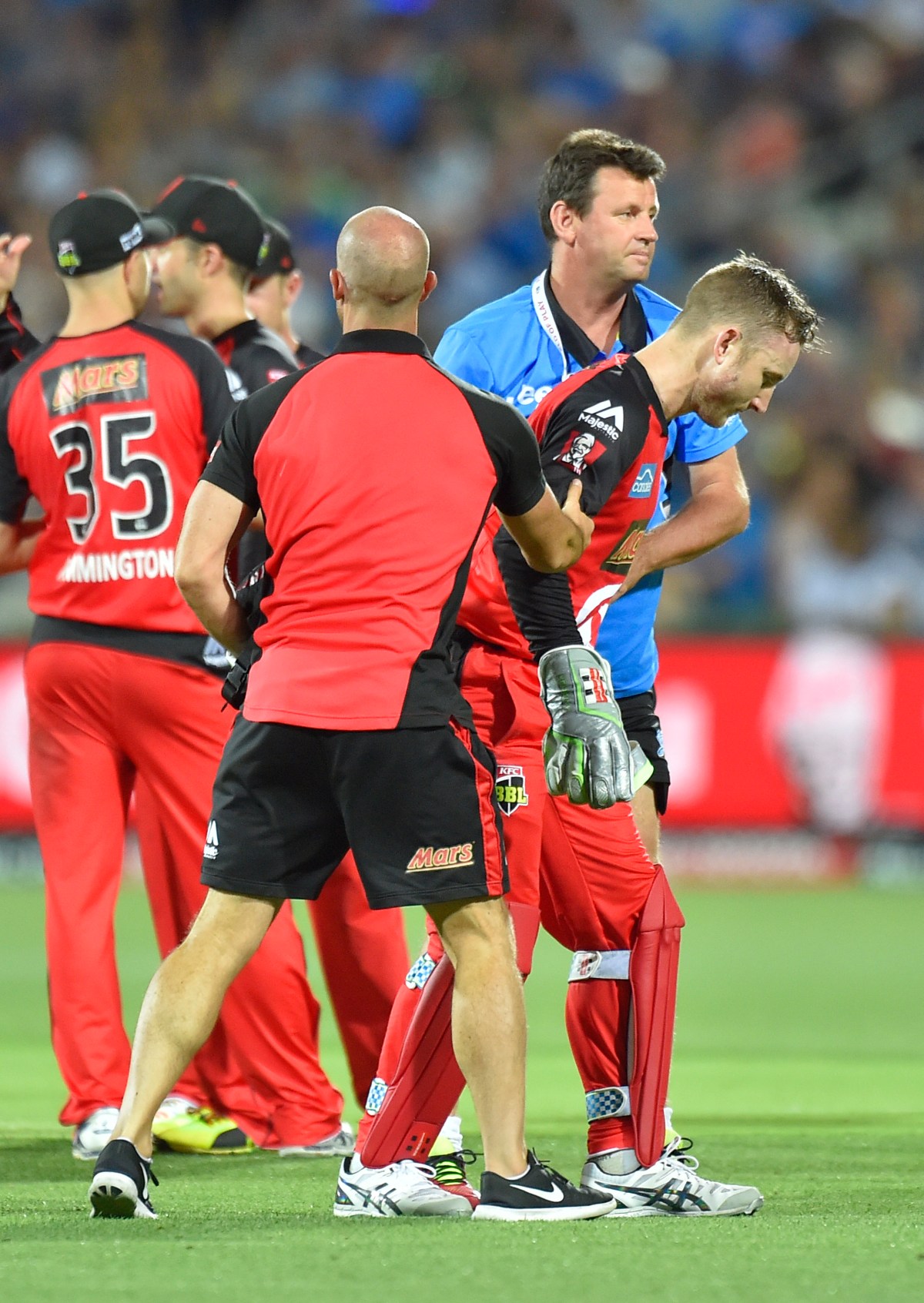 Peter Nevill of the Melbourne Renegades is helped of the field during the BBL T20 match between the Adelaide Strikers and the Melbourne Renegades at the Adelaide Oval in Adelaide, Monday, Jan. 16, 2017. (AAP Image/David Mariuz) NO ARCHIVING, EDITORIAL USE ONLY, IMAGES TO BE USED FOR NEWS REPORTING PURPOSES ONLY, NO COMMERCIAL USE WHATSOEVER, NO USE IN BOOKS WITHOUT PRIOR WRITTEN CONSENT FROM AAP