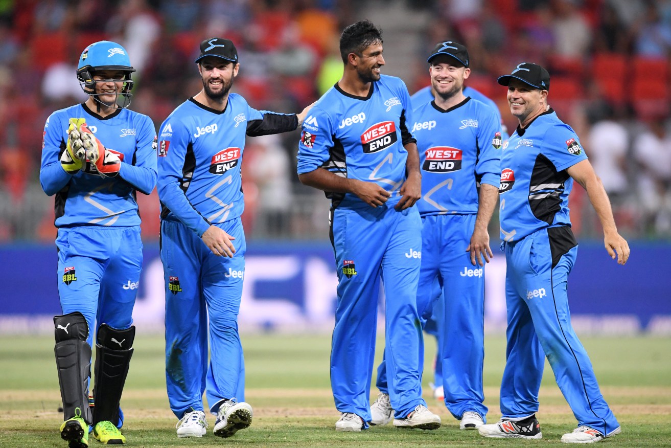 Ish Sodhi (centre) is congratulated after taking the wicket of Chris Green. Photo: Paul Miller / AAP
