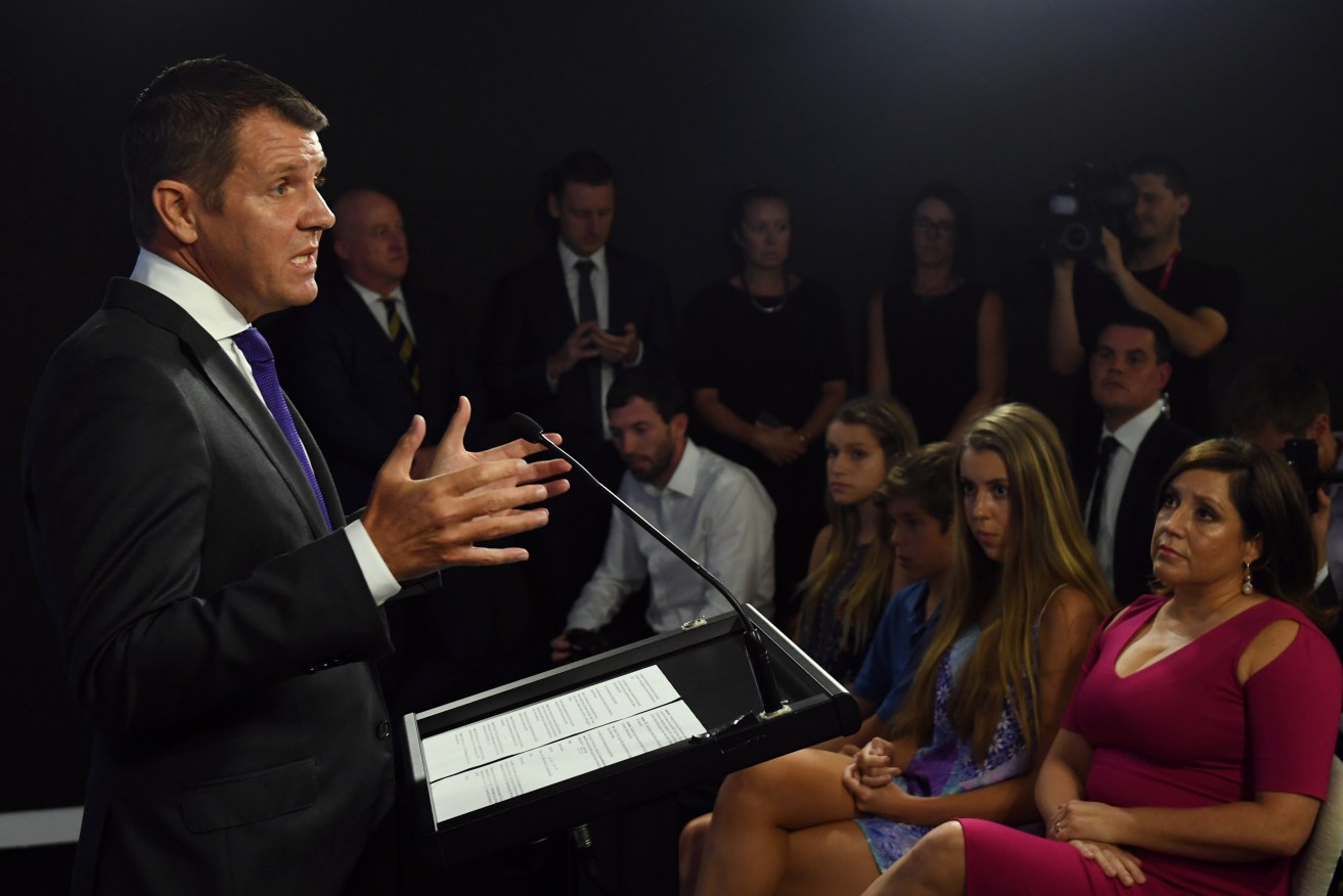 NSW Premier Mike Baird at his resignation press conference as his wife Kerryn and children Cate, Luke and Laura look on. Photo: AAP/Paul Miller