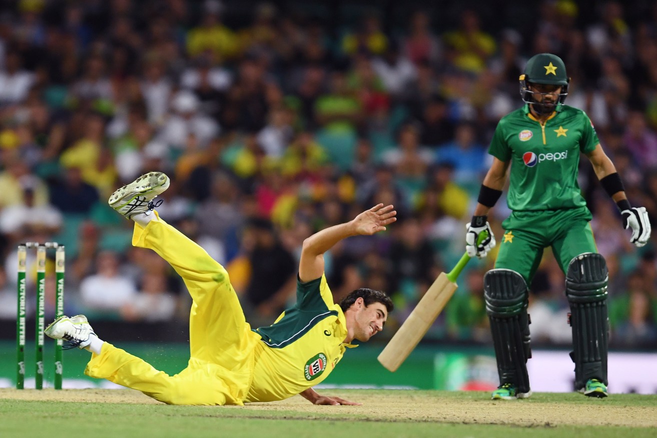 Mitch Starc loses his footing after a delivery as Australia trounces Pakistan at the SCG. Photo: Paul Miller / AAP
