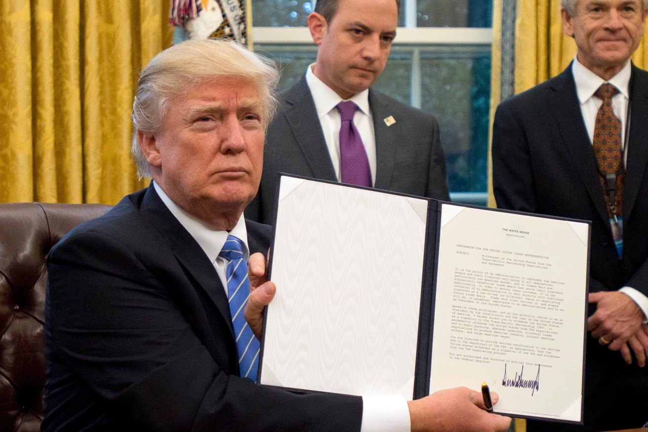 President Donald Trump shows the Executive Order withdrawing the US from the Trans-Pacific Partnership. Photo: EPA/Ron Sachs