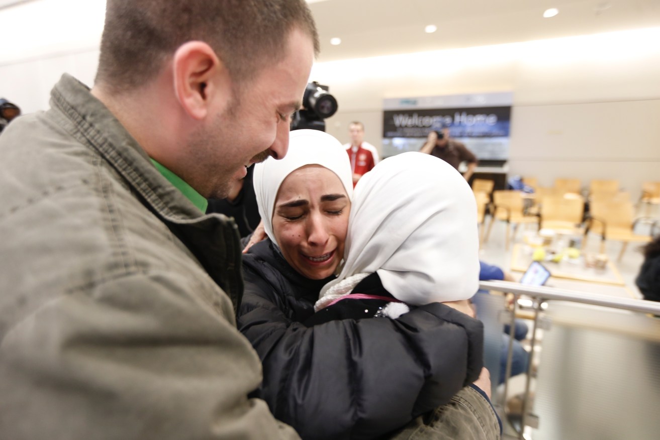 Hisham (left) and Mariam Yasin (centre) welcome their mother Najah Alshamieh, from Syria, after immigration authorities released her at Dallas Fort Worth Airport. Alshamieh was held by immigration authorities after President Donald Trump signed an executive order barring Muslims from certain countries from entering the Unties States. Photo: Brandon Wade/Star-Telegram via AP