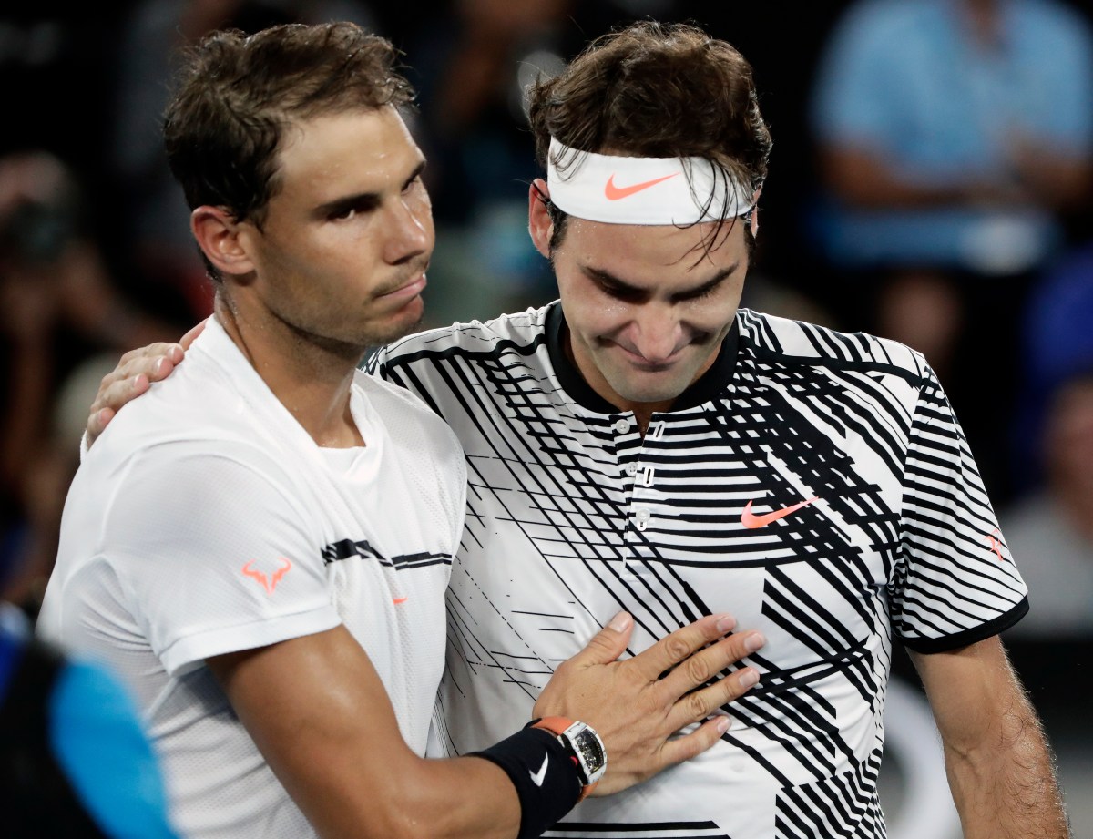 Roger Federer (R) of Switzerland is congratulated by Rafael Nadal (L) of Spain after winning their Men's Singles final match at the Australian Open Grand Slam tennis tournament in Melbourne, Victoria, Australia, 29 January 2017.(AAP Image/Mark Cristino) NO ARCHIVING, EDITORIAL USE ONLY