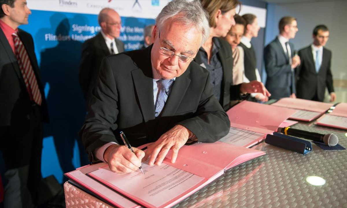 Flinders Deputy Vice-Chancellor (Research) Professor Robert Saint signs the MoU at the DCNS headquarters in Paris last week. 