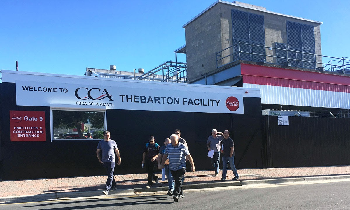 Workers outside the Coca Cola Amatil plant at Thebarton this morning.