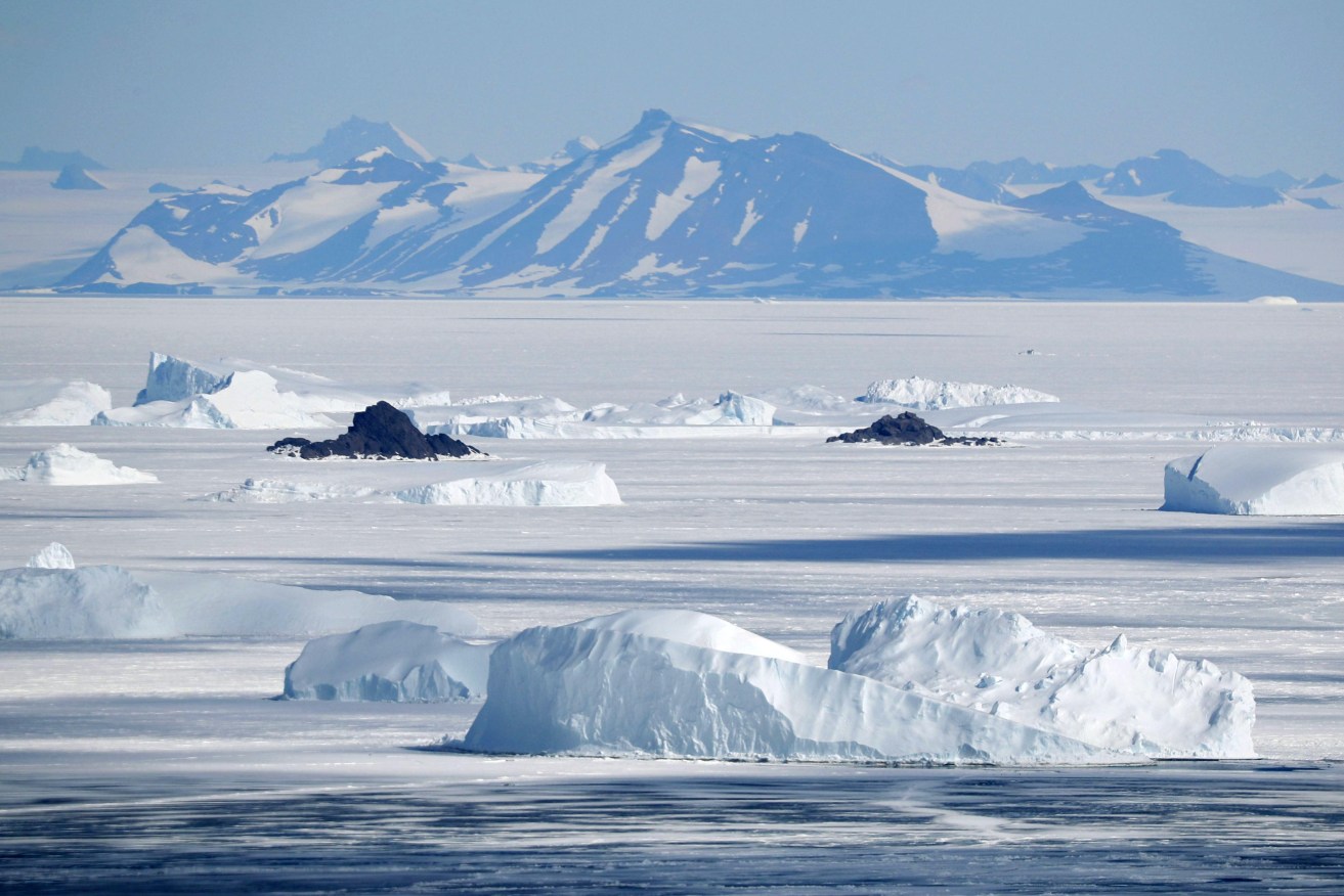 Mountains in Antarctica and ice floating in the Antarctic Sea.