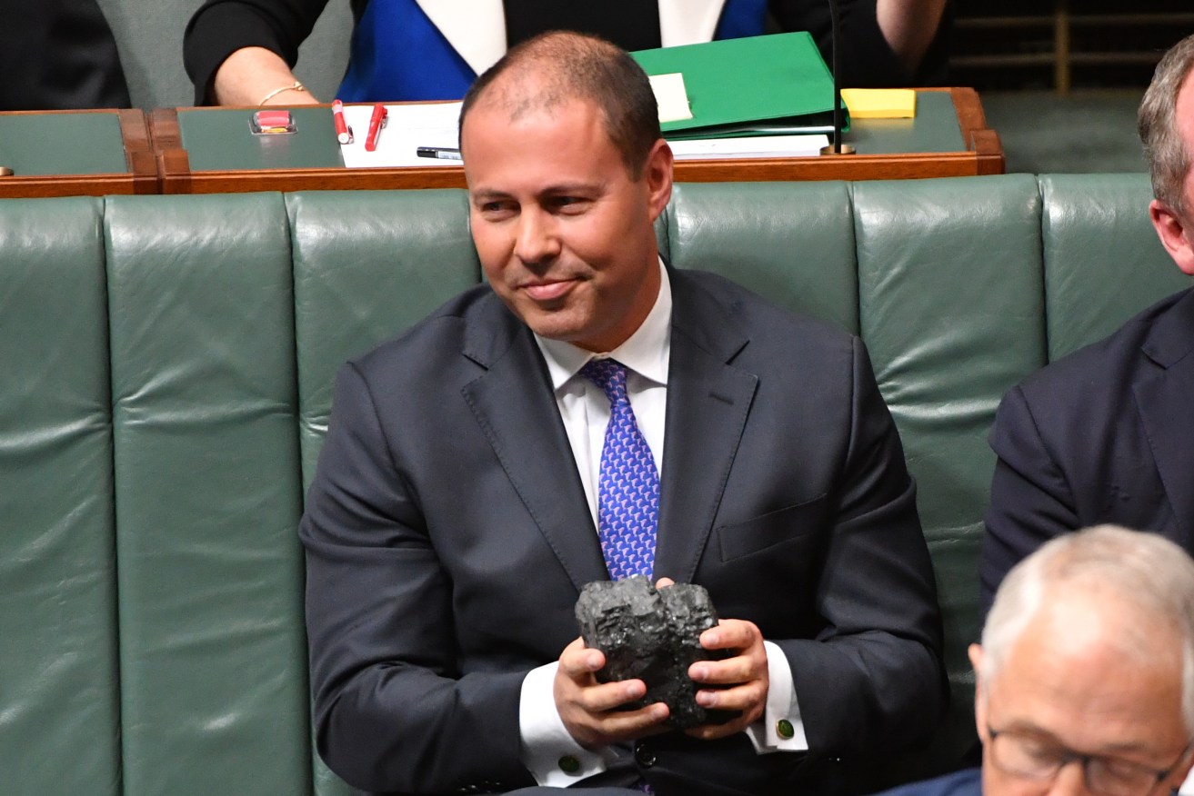 Minister for Environment and Energy Josh Frydenberg with a lump of coal during Question Time earlier this month. Photo: AAP/Mick Tsikas