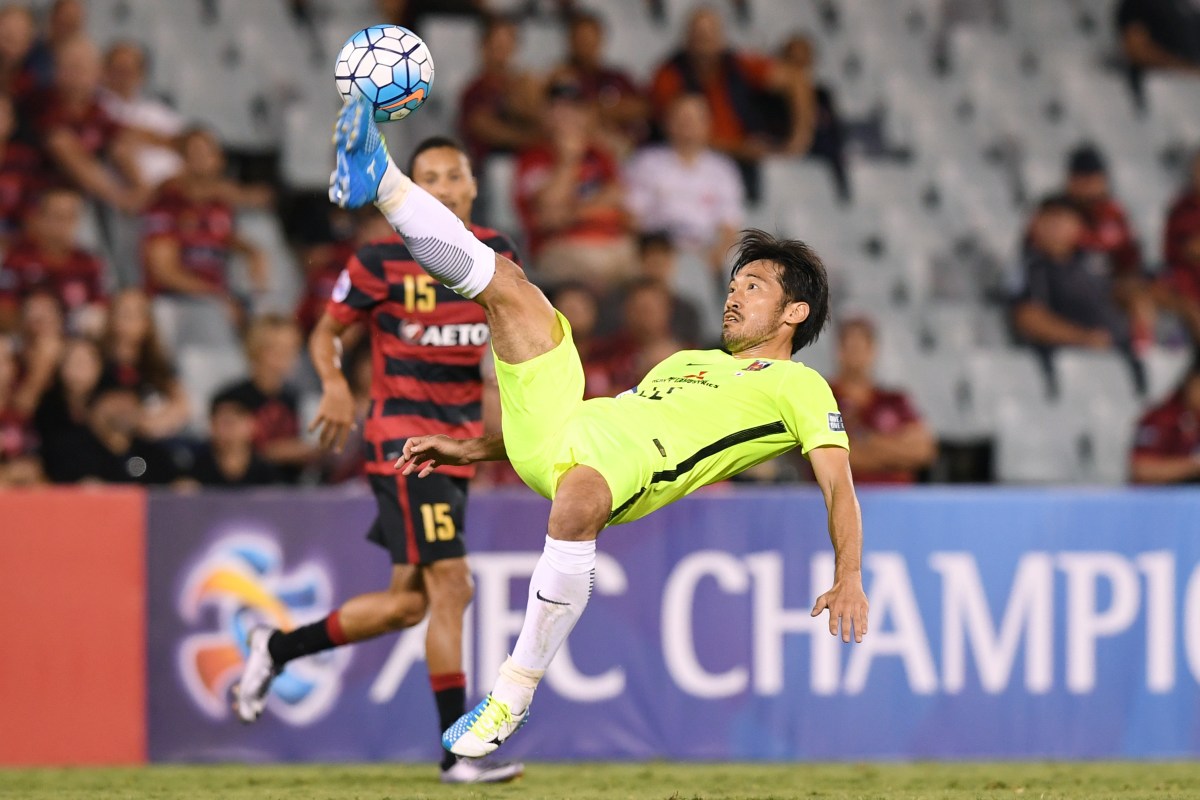 Yuki Abe (right) of the Red Diamonds clears the ball during the group F AFC Champions League match between the Western Sydney Wanderers and the Urawa Red Diamonds at Campbelltown Stadium in Sydney on Tuesday, Feb. 21, 2017. (AAP Image/Paul Miller) NO ARCHIVING, EDITORIAL USE ONLY
