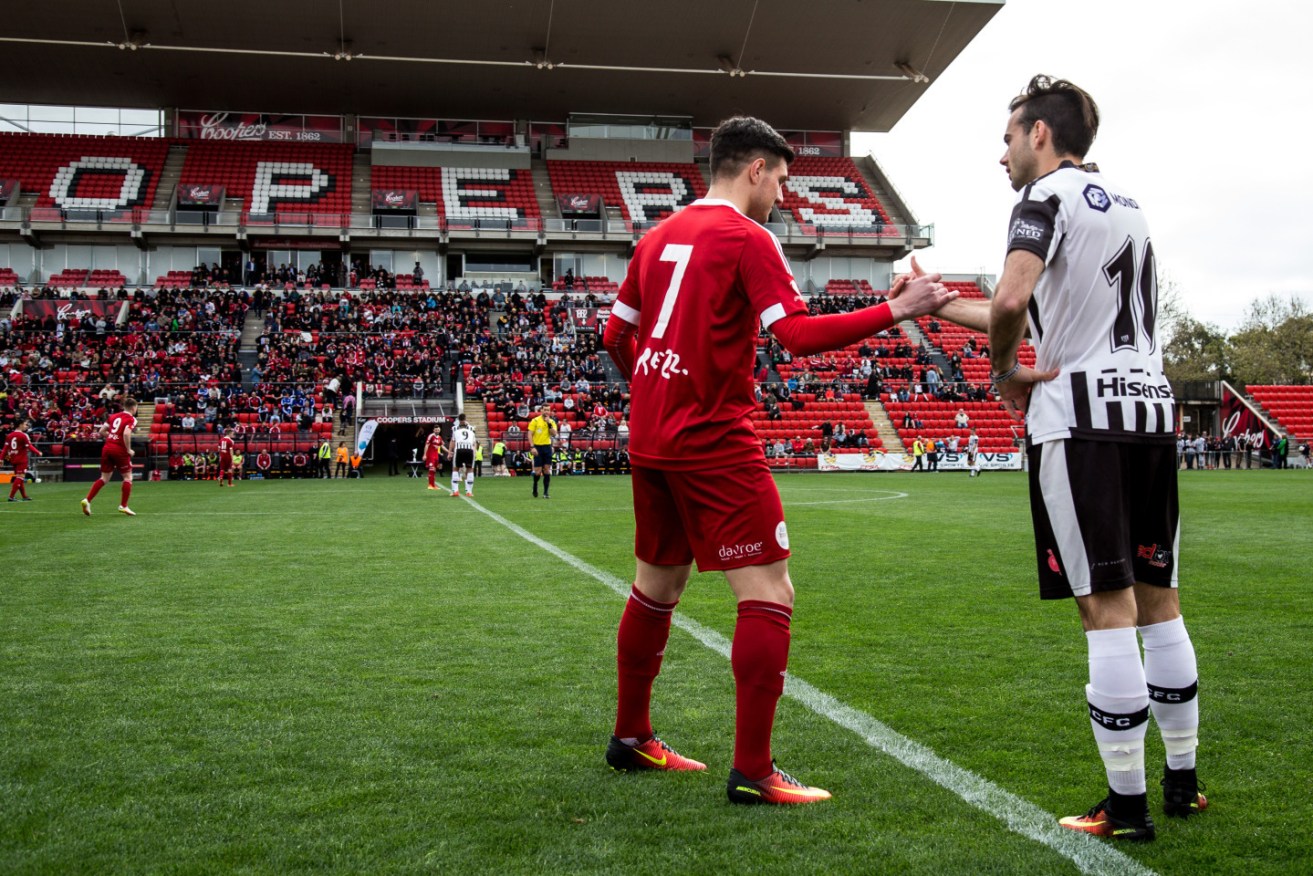 Campbelltown City’s Luigi Di Troia and Adelaide City’s Nikola Mileusnic (now with Adelaide United) shake hands before last year’s grand final. Photo: Supplied.