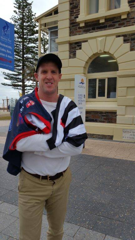 Holdfast Bay mayor Stephen Patterson draped with the jumpers of his two football clubs - Norwood and Collingwood. Photo: Facebook