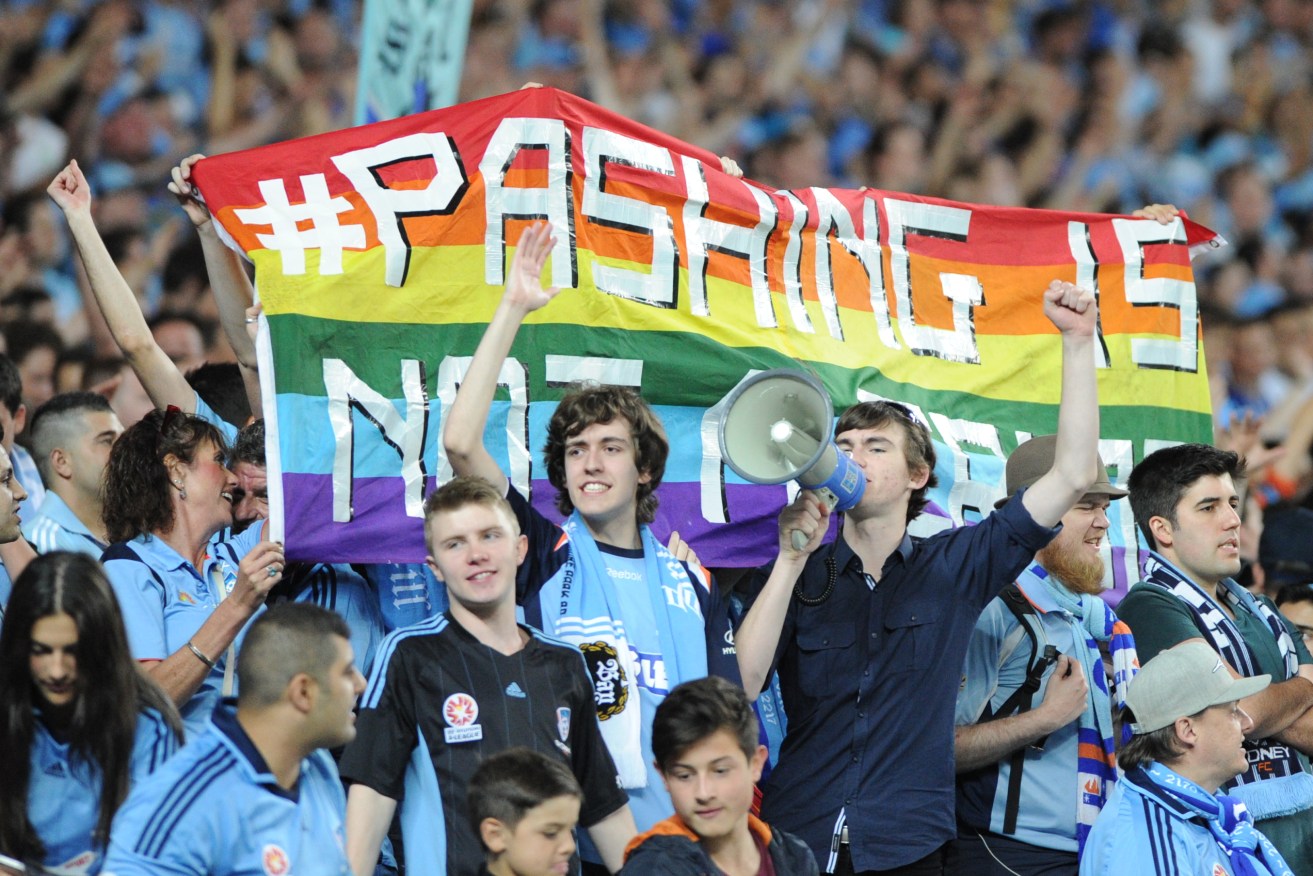 Sydney FC fans in The Cove holding up a rainbow banner in 2013. Photo: Dean Lewins / AAP