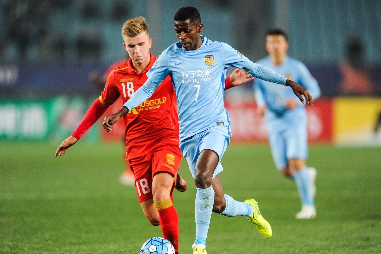 Potential Socceroos debutant Riley McGree garners some attention from Brazilian Ramires of China's Jiangsu Suning FC while playing for Adelaide United in the AFC Champions League earlier this month. Photo via AAP