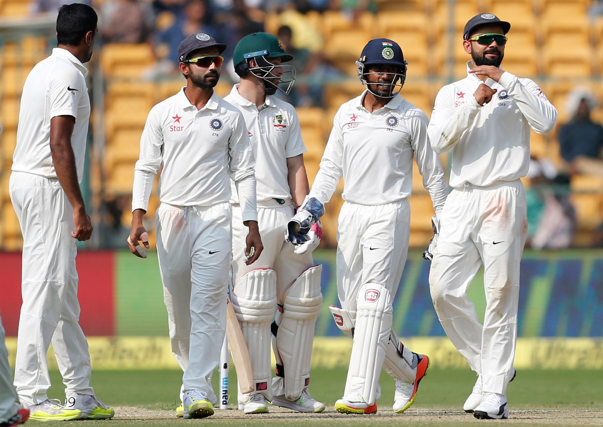 India's captain Virat Kohli, right, gestures to ask for a television review for the wicket of Australia's Matthew Wade, center, during the second day of their second test cricket match in Bangalore, India, Sunday, March 5, 2017. (AP Photo/Aijaz Rahi)