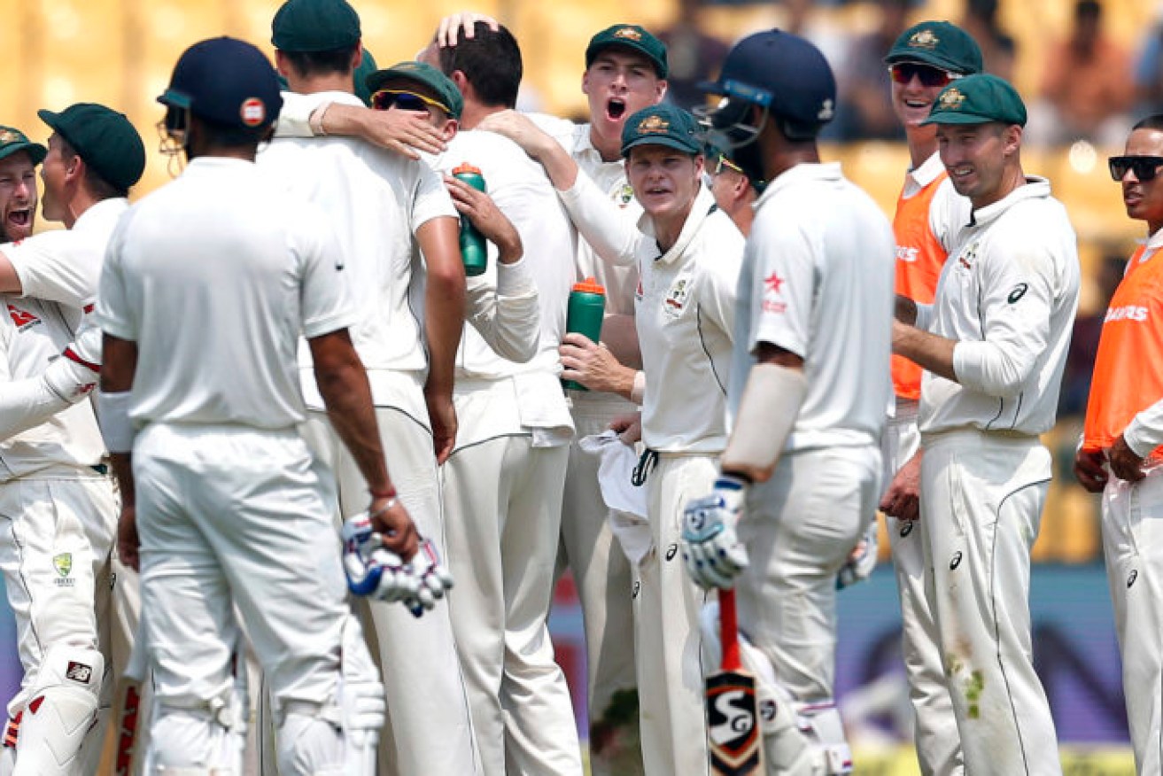 SO CLOSE, BUT SO FAR: Australian players celebrate the dismissal of India's captain Virat Kohli during the second Test in Bangalore. Photo: Aijaz Rahi / AP