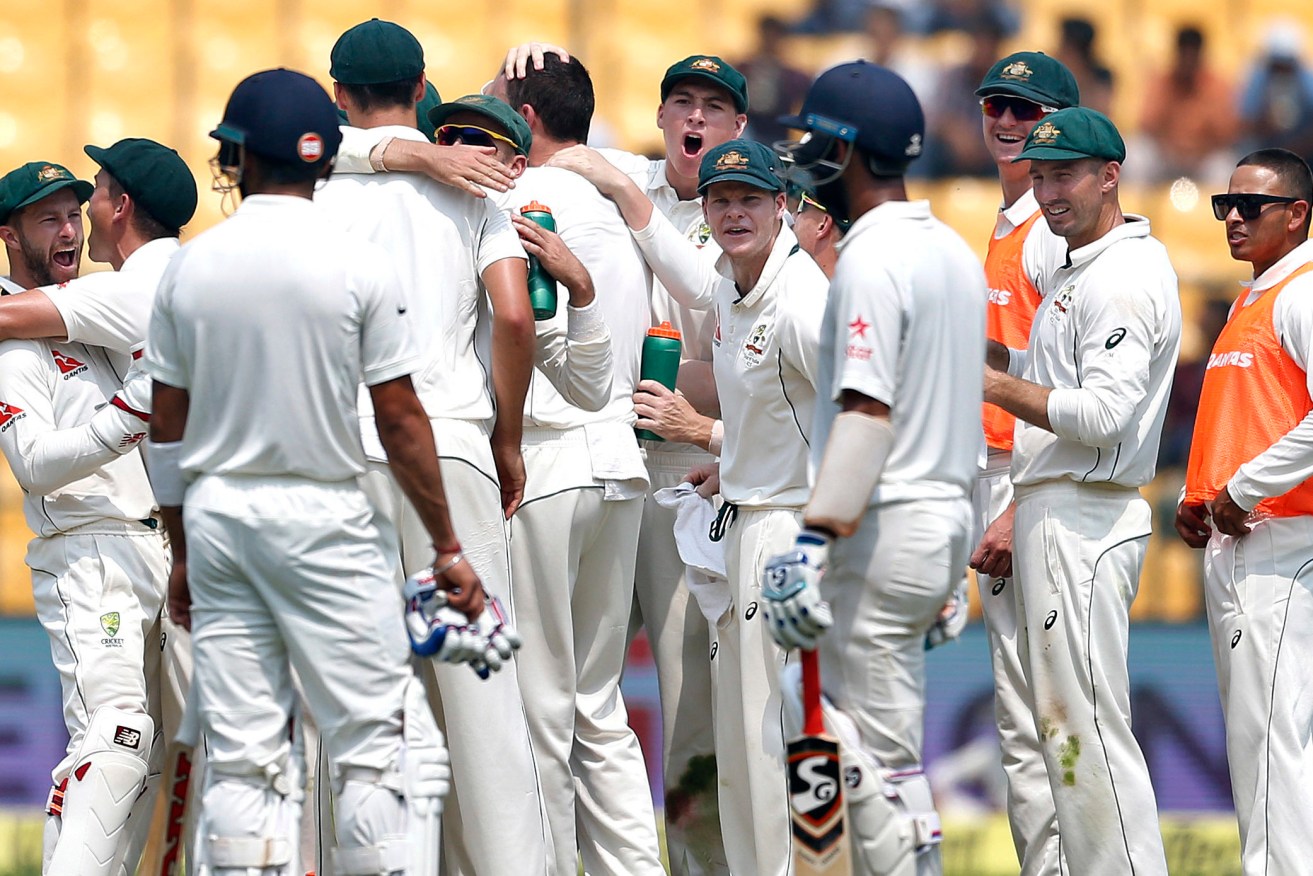 Australian players, with Steve Smith in the centre, celebrate yesterday's dismissal of India captain Virat Kohli. Photo: Aijaz Rahi / AP
