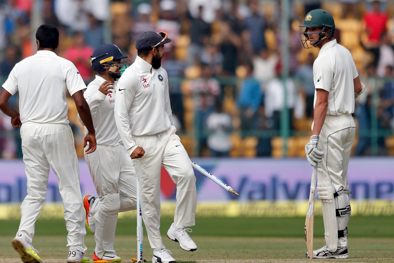 Virat Kohli exchanges pleasantries with Australia's last man standing Josh Hazlewood as India celebrate a 75-run victory in the second Test. Photo: Aijaz Rahi / AP