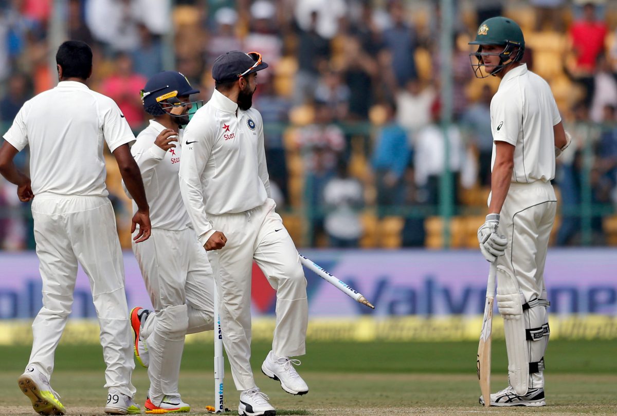 Virat Kohli exchanges pleasantries with Australia's last man standing Josh Hazlewood as India celebrate a 75-run victory in the second Test. Photo: Aijaz Rahi / AP