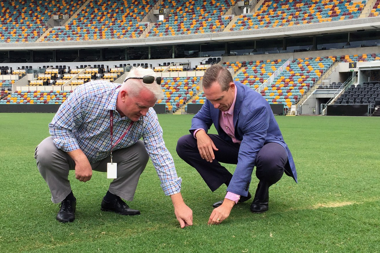 Queensland Sports Minister Mick de Brennii (right) and Gabba venue manager Blair Conaghan inspecting the pitch following the Adele concerts last week. Photo: Stuart Layt / AAP