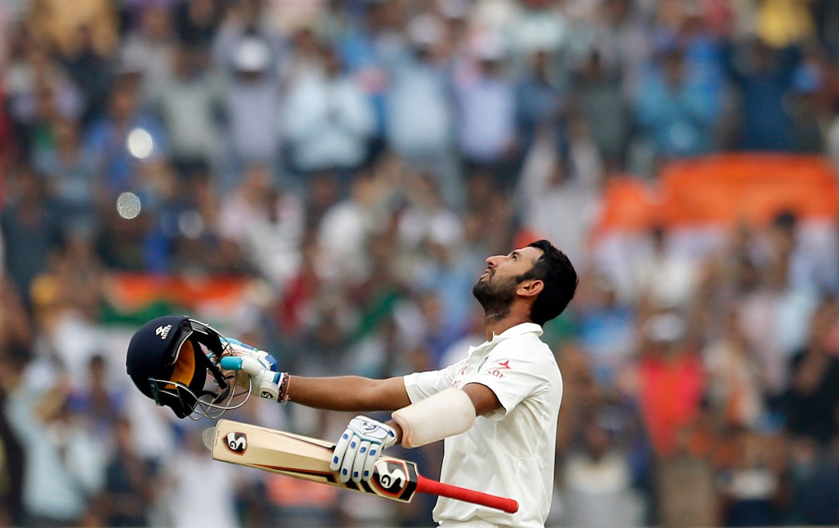 India's Cheteshwar Pujara looks skywards as he raises his bat and helmet to celebrate scoring double century during the fourth day of the third test cricket match against Australia in Ranchi, India, Sunday, March 19, 2017. (AP Photo/Aijaz Rahi)