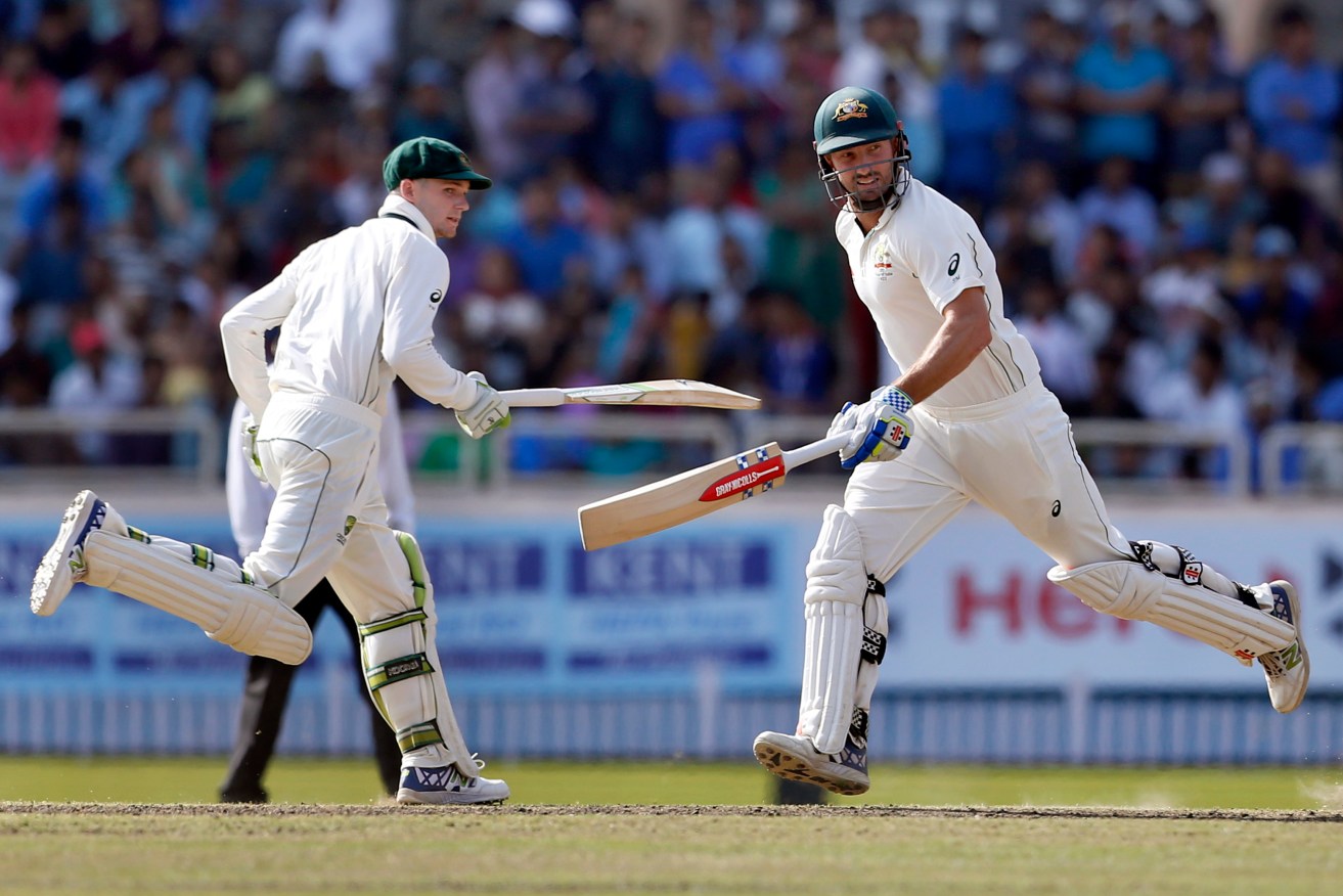 Shaun Marsh (right) and Peter Handscomb run between the wickets yesterday. Photo: Aijaz Rahi / AP