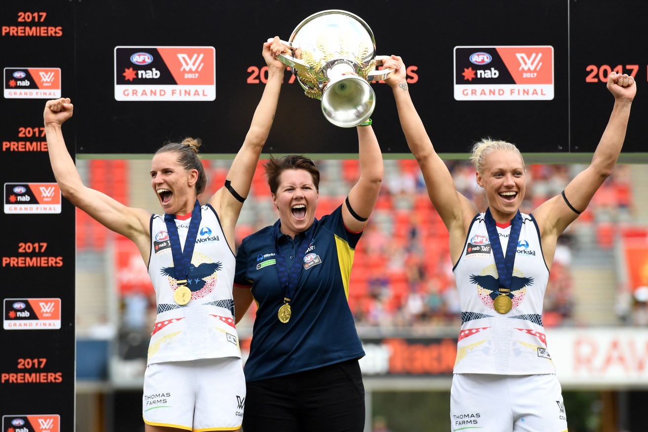 Coach Bec Goddard (centre) celebrates the Crows premiership with co-captains Chelsea Randall (left) and Erin Phillips. Photo: Dan Peled / AAP
