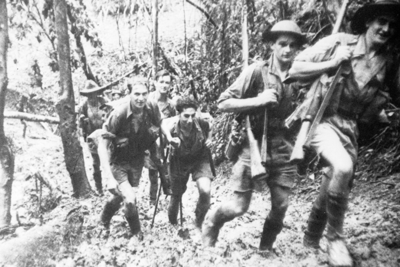 Members of D Company, 39th Battalion, returning to their base camp after a battle at Isurava on the Kokoda track in Papua New Guinea. (L to R:) Warrant Officer 2 R. Marsh, Private (Pte) George Palmer, Pte J. Manol, Pte J. Tonkins, Pte A. Forrester and Gallipoli veteran Staff Sergeant J. Long. Photo: AAP/Australian War Memorial, Damien Parer