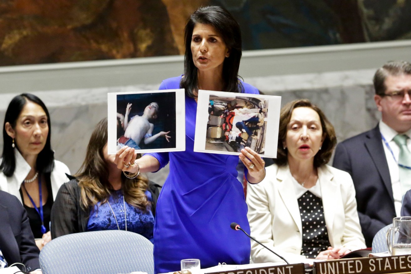 Nikki Haley, the United States' Ambassador to the United Nations, shows pictures of Syrian victims of chemical attacks as she addresses a meeting of the Security Council. Photo: AP/Bebeto Matthews