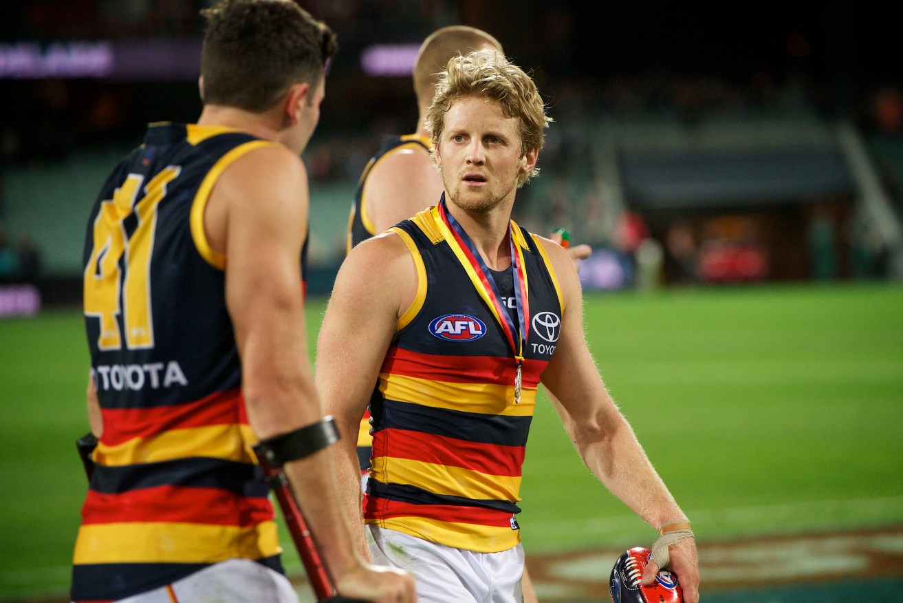 Showdown medallist Rory Sloane checks on the injured Mitch McGovern after Saturday's game. Photo: Michael Errey / InDaily