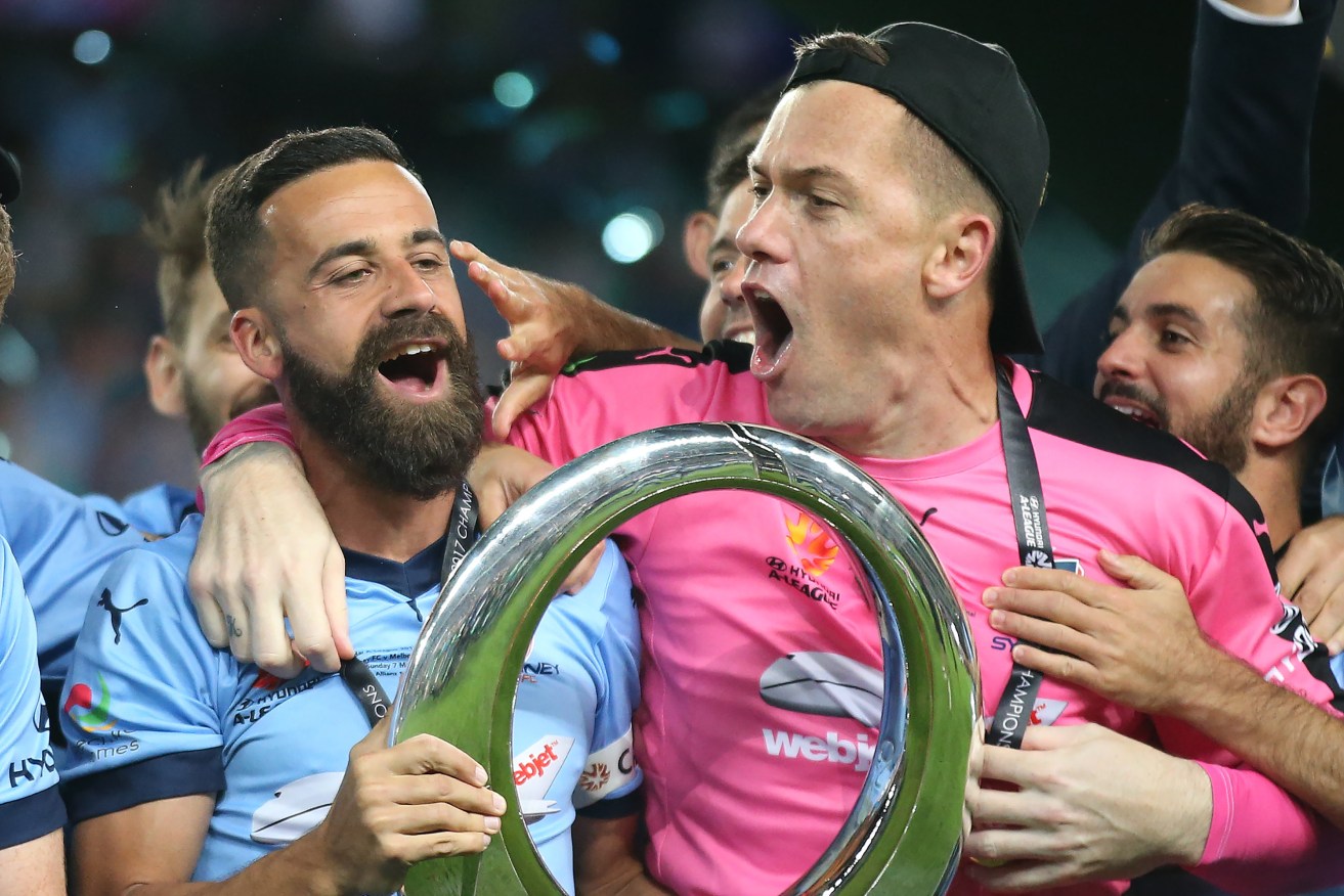 Sydney's Alex Brosque and goalkeeper Danny Vukovic celebrate with teammates after winning the A-League Grand Final. Photo: David Moir / AAP