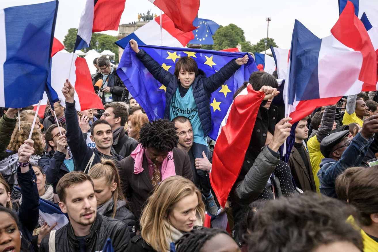 Supporters of Emmanuel Macron (not pictured) gather at the Carrousel du Louvre. Photo: EPA/Christophe Petit Tesson
