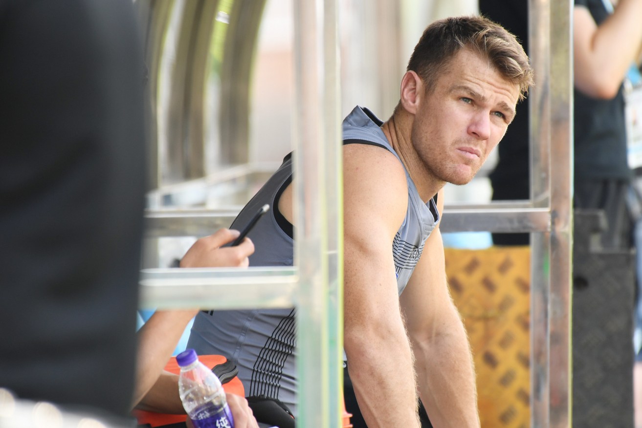 Robbie Gray sits on the bench after having has his ankle strapped during training at Jiangwan Stadium. Photo: Tracey Nearmy / AAP