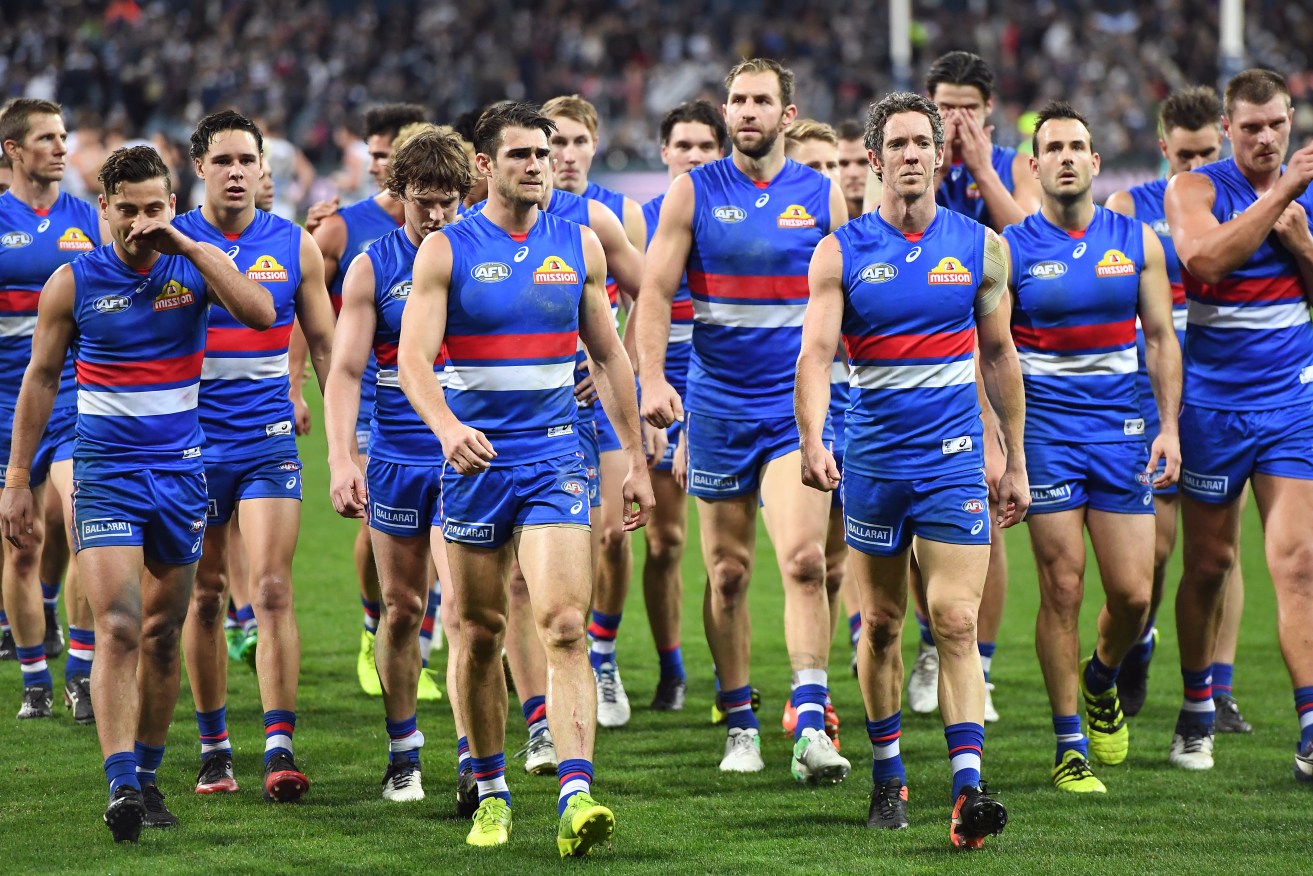 Bob Murphy leads his team from the ground after losing to Geelong Cats last week. Photo: Julian Smith / AAP